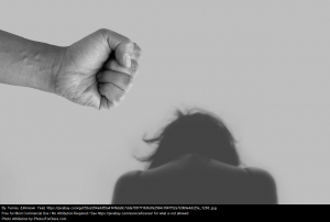 image of fist and person looking down to signify family violence